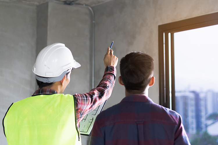 Client and Contractor discussing plan to renovation house. Client and Contractor discussing plan to renovation house.